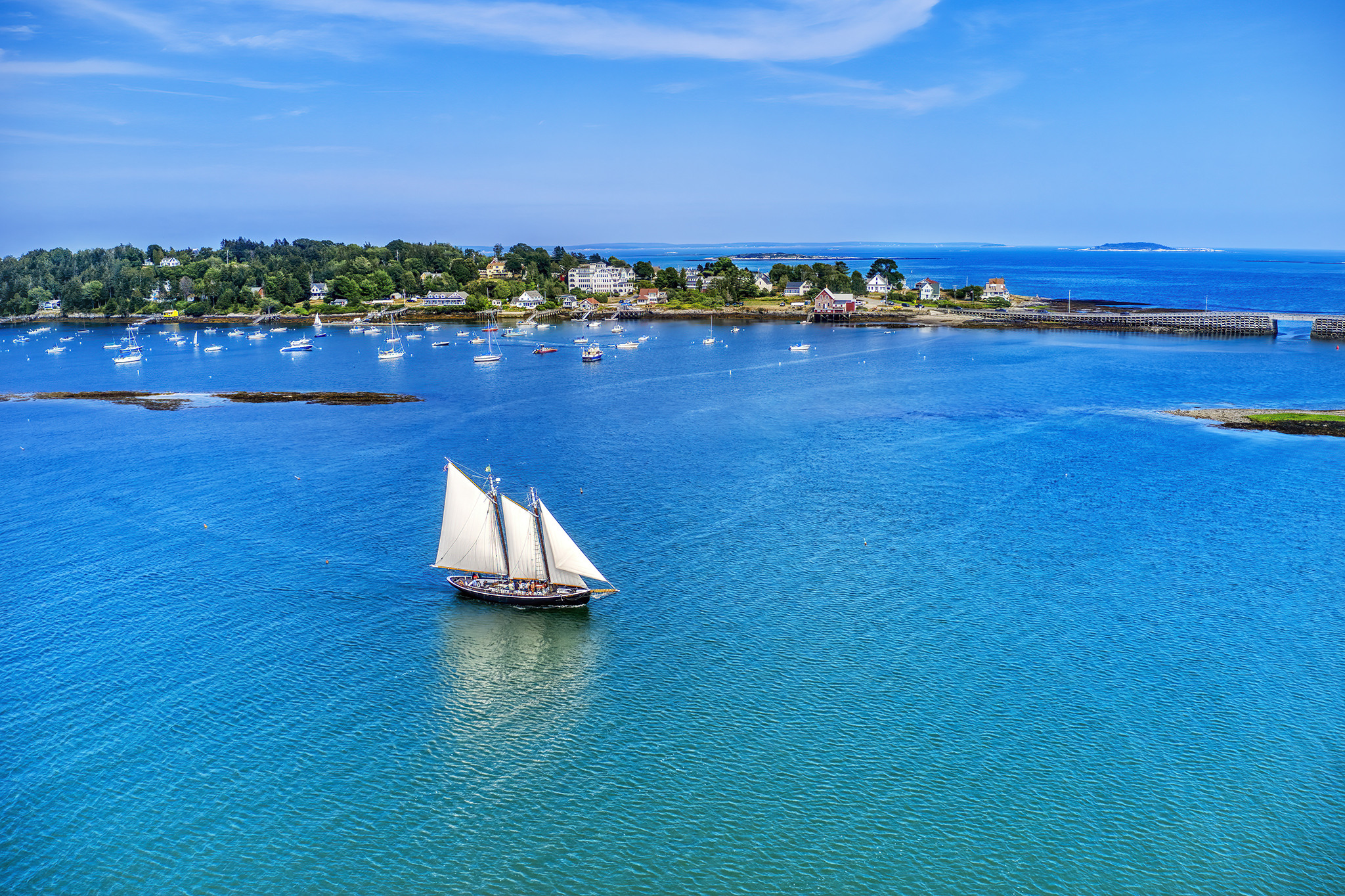 Drone aerial view of a sailboat in open water.
Fine art aerial image of a schooner at sea, demonstrating precise low-altitude control.